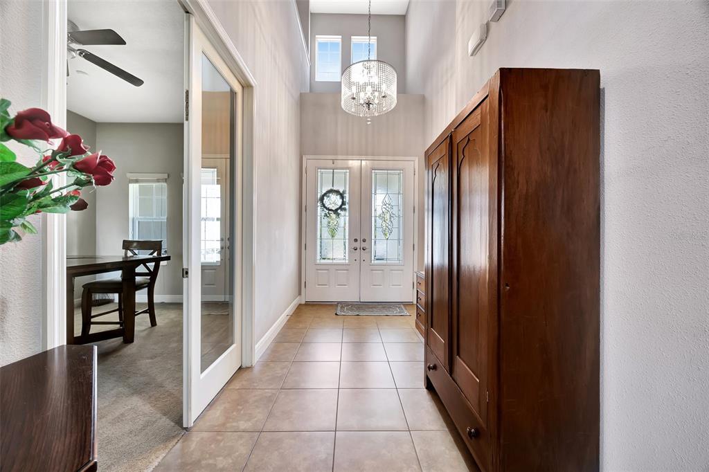 6324 Brevada Lane Apollo Beach, FL 33572 - Photo 30 of 45 a view of a hallway to dining room and chandelier