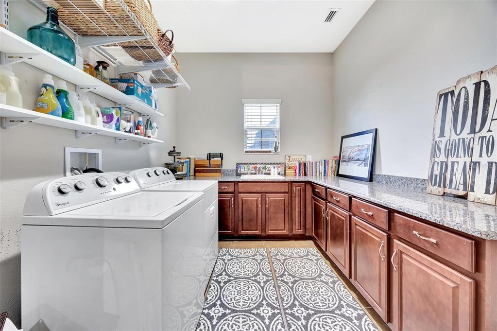 6324 Brevada Lane Apollo Beach, FL 33572 - Photo 33 of 45 a kitchen with a sink and a stove top oven