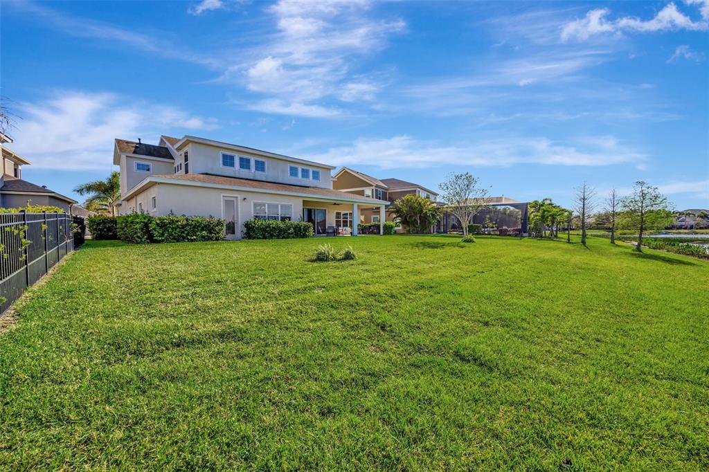 6324 Brevada Lane Apollo Beach, FL 33572 - Photo 44 of 45 a view of a big house with a big yard and large trees