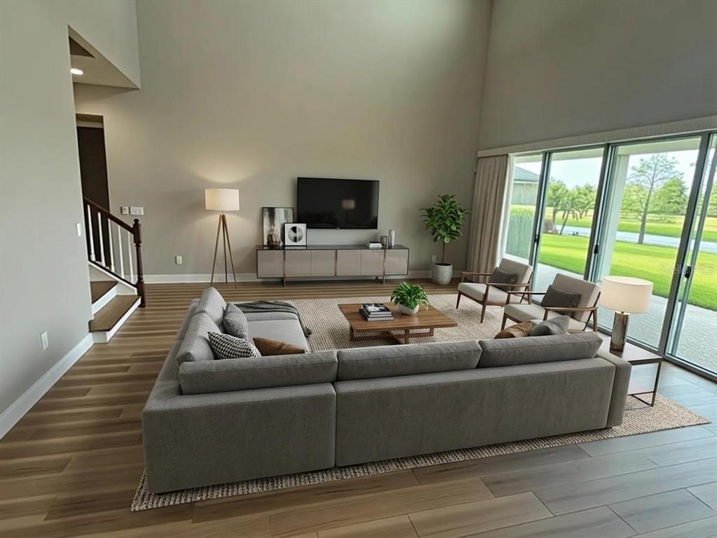 6324 Brevada Lane Apollo Beach, FL 33572 - Photo 5 of 45 a living room with furniture and a flat screen tv