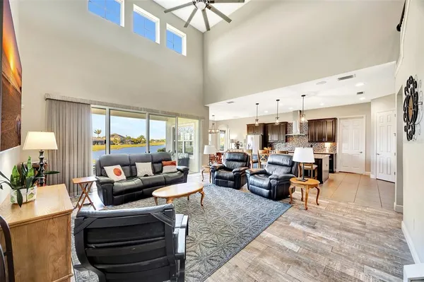 a living room with furniture fireplace and a large window