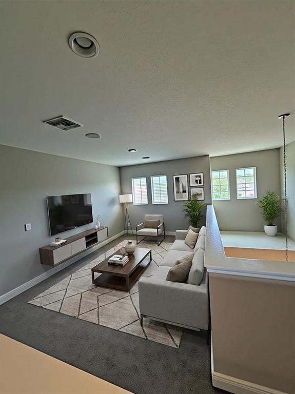6324 Brevada Lane Apollo Beach, FL 33572 - Photo 7 of 45 a living room with furniture and a flat screen tv