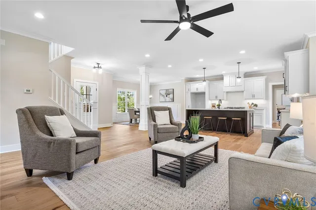 a living room with furniture and a view of kitchen