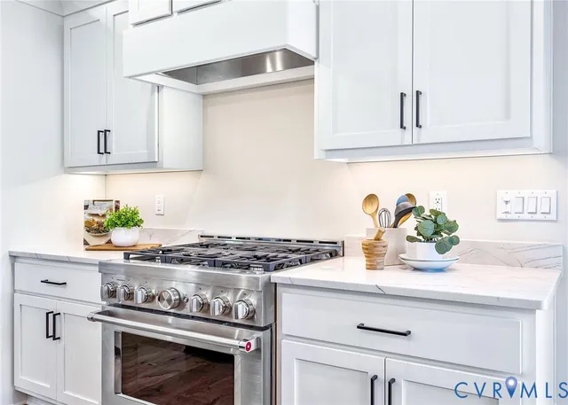 a kitchen with white cabinets and appliances