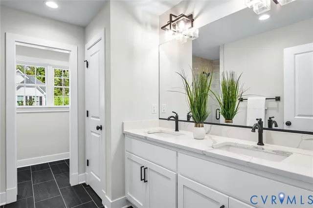 a bathroom with a double vanity sink and a mirror