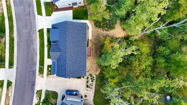 an aerial view of a house with garden space and street view