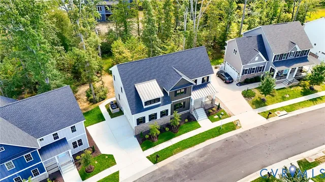an aerial view of a house with garden space and street view