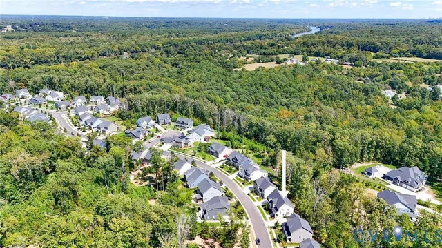 an aerial view of a houses with a lush green hillside