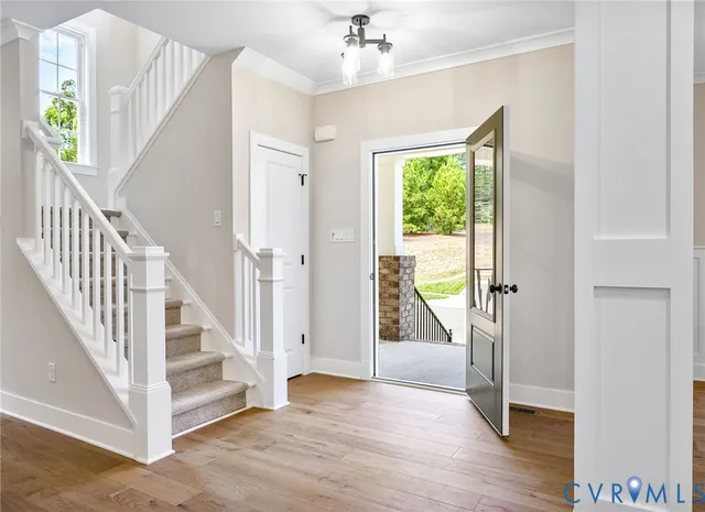 a view of front door and hallway with wooden floor