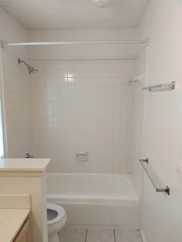 a bathroom with a toilet and a bathtub