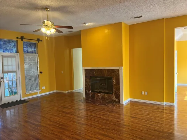 a view of a livingroom with a fireplace and window