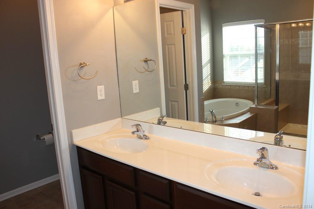 409 Armour Street Davidson, NC 28036 - Photo 13 of 24 a bathroom with a sink and a mirror