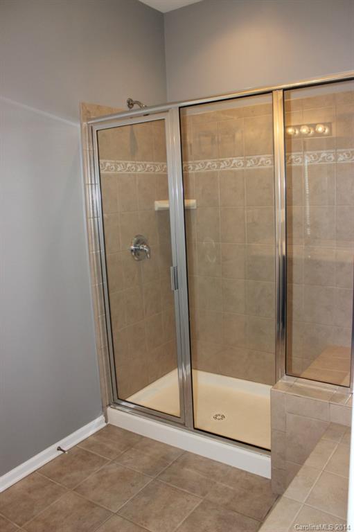 409 Armour Street Davidson, NC 28036 - Photo 14 of 24 a bathroom with a glass shower door