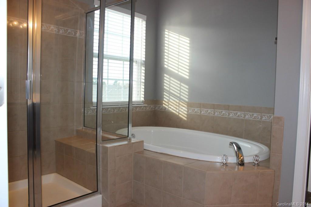 409 Armour Street Davidson, NC 28036 - Photo 15 of 24 a bathroom with a tub and shower