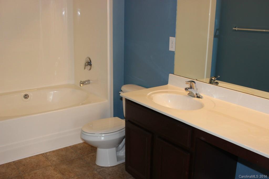 409 Armour Street Davidson, NC 28036 - Photo 17 of 24 a bathroom with a sink a toilet and a bathtub