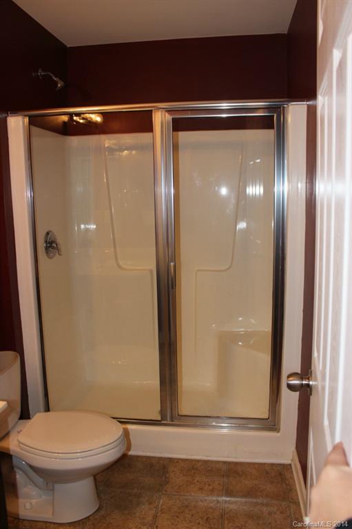 409 Armour Street Davidson, NC 28036 - Photo 21 of 24 a bathroom with a glass shower door