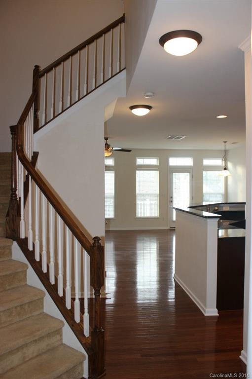 409 Armour Street Davidson, NC 28036 - Photo 4 of 24 a view of staircase and kitchen with wooden floor