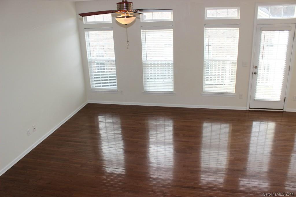 409 Armour Street Davidson, NC 28036 - Photo 8 of 24 a view of empty room with wooden floor and fan