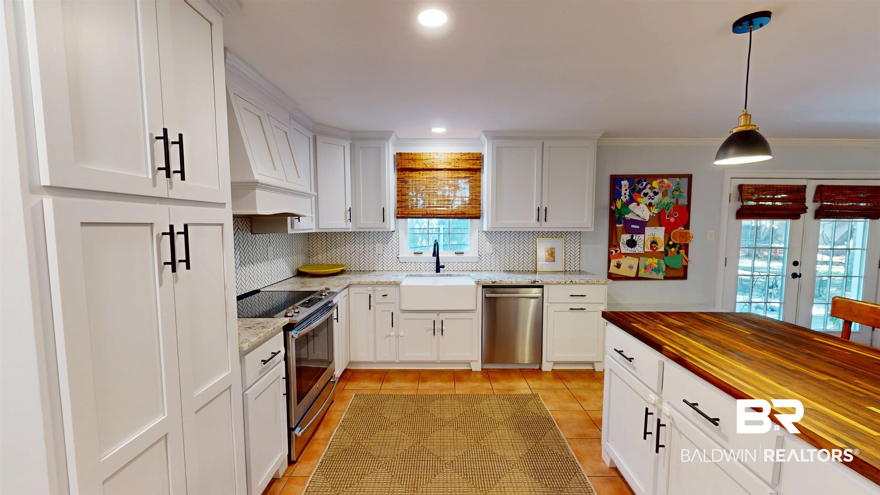 163 Fenwick Road Mobile, AL 36608 - Photo 16 of 25 Kitchen with stainless steel appliances, white cabinets, pendant lighting, decorative backsplash, and custom exhaust hood