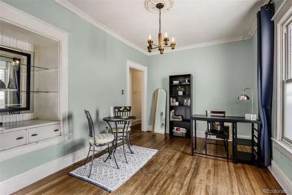 a view of a dining room with furniture wooden floor and chandelier