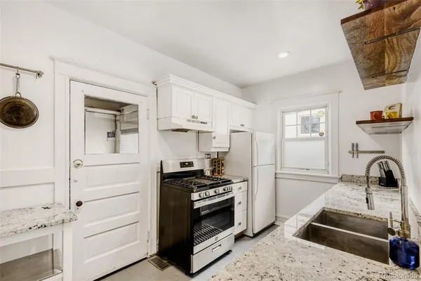 a kitchen with a sink and a stove top oven