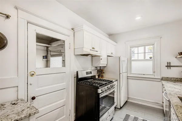 a kitchen with a refrigerator and a stove