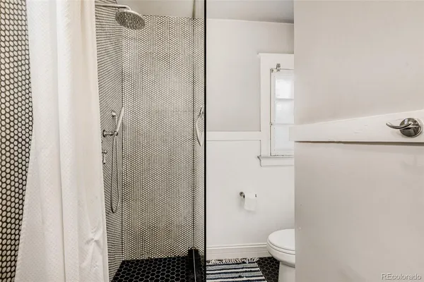 a bathroom with a granite countertop shower