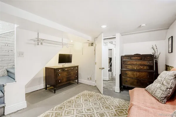 a living room with furniture and a dresser