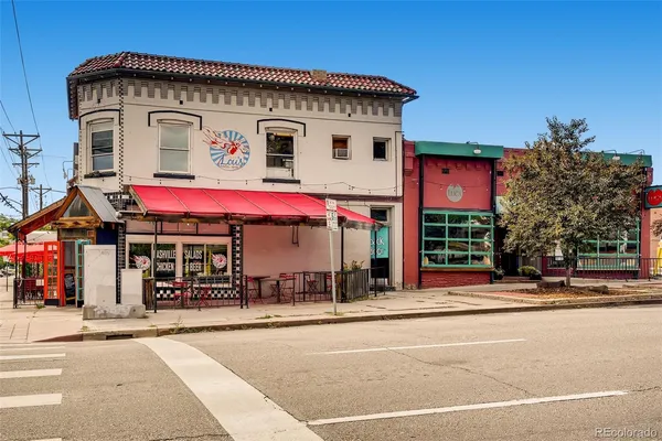 a view of a brick building with a bench in front of building