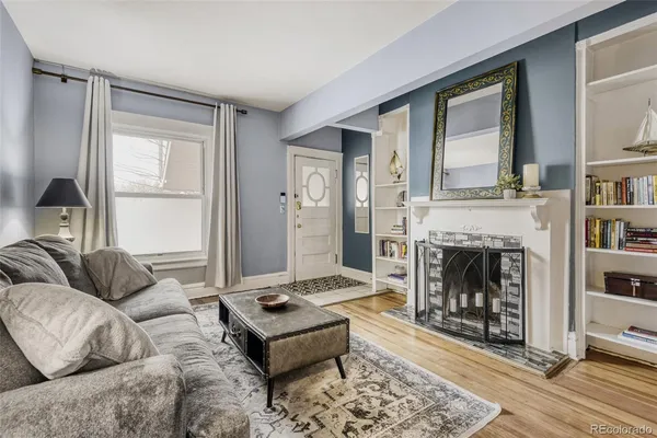 a living room with furniture and a fireplace