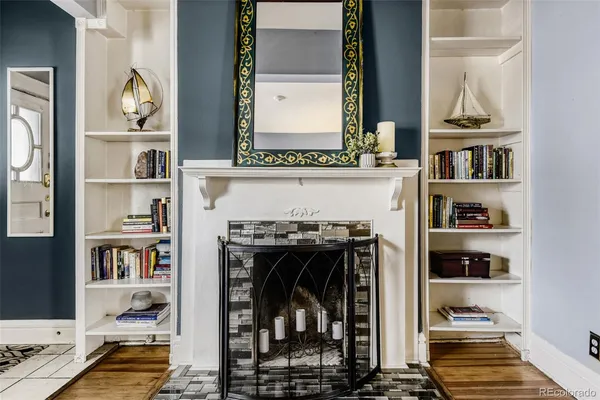 a living room with fireplace and furniture