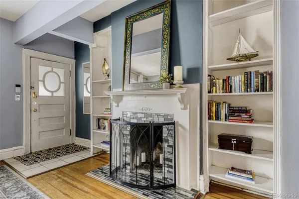 a view of living room with furniture and a fireplace