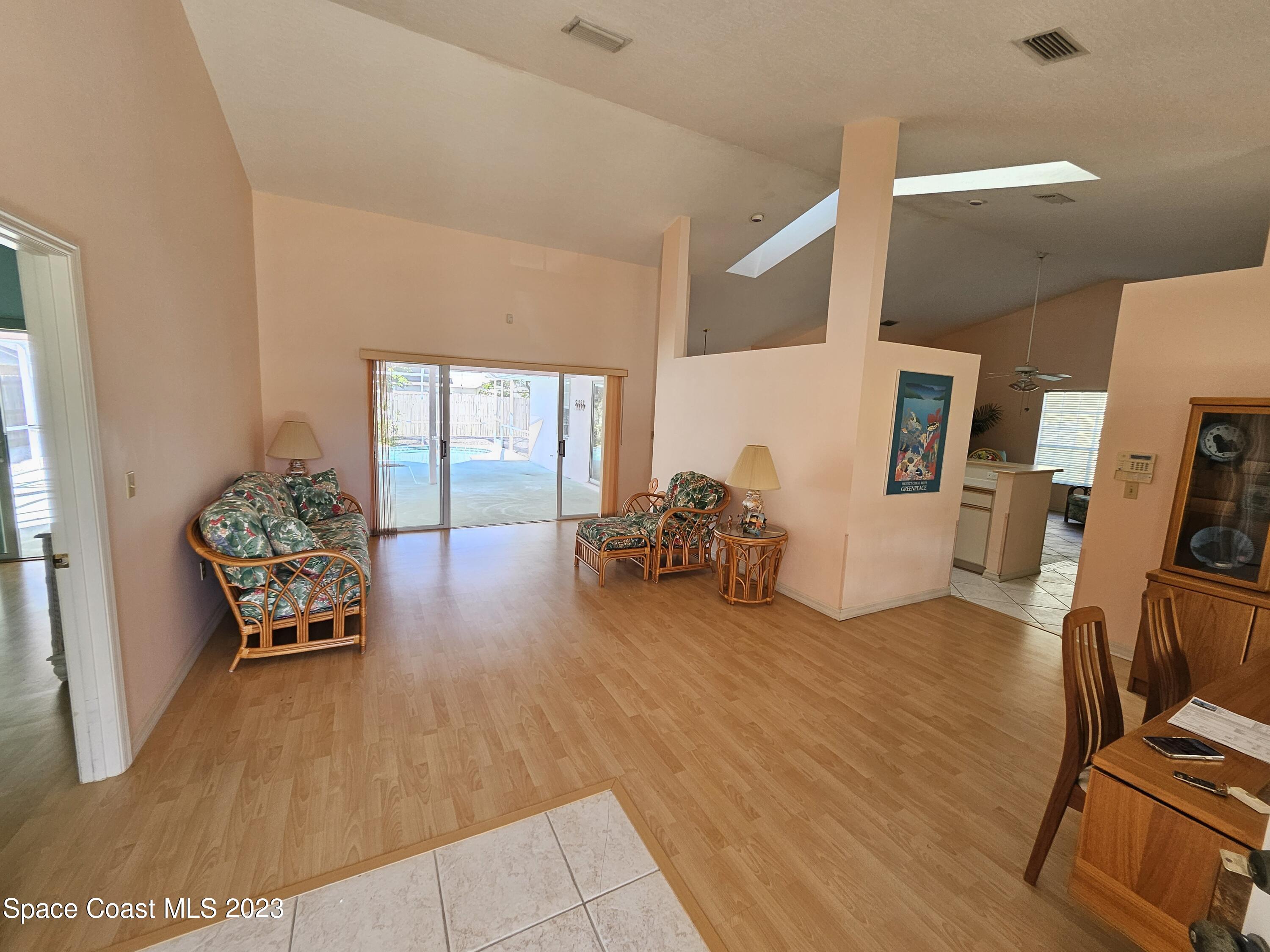 1910 Glen Meadows Circle Melbourne, FL 32935 - Photo 11 of 28 a living room with furniture and a wooden floor