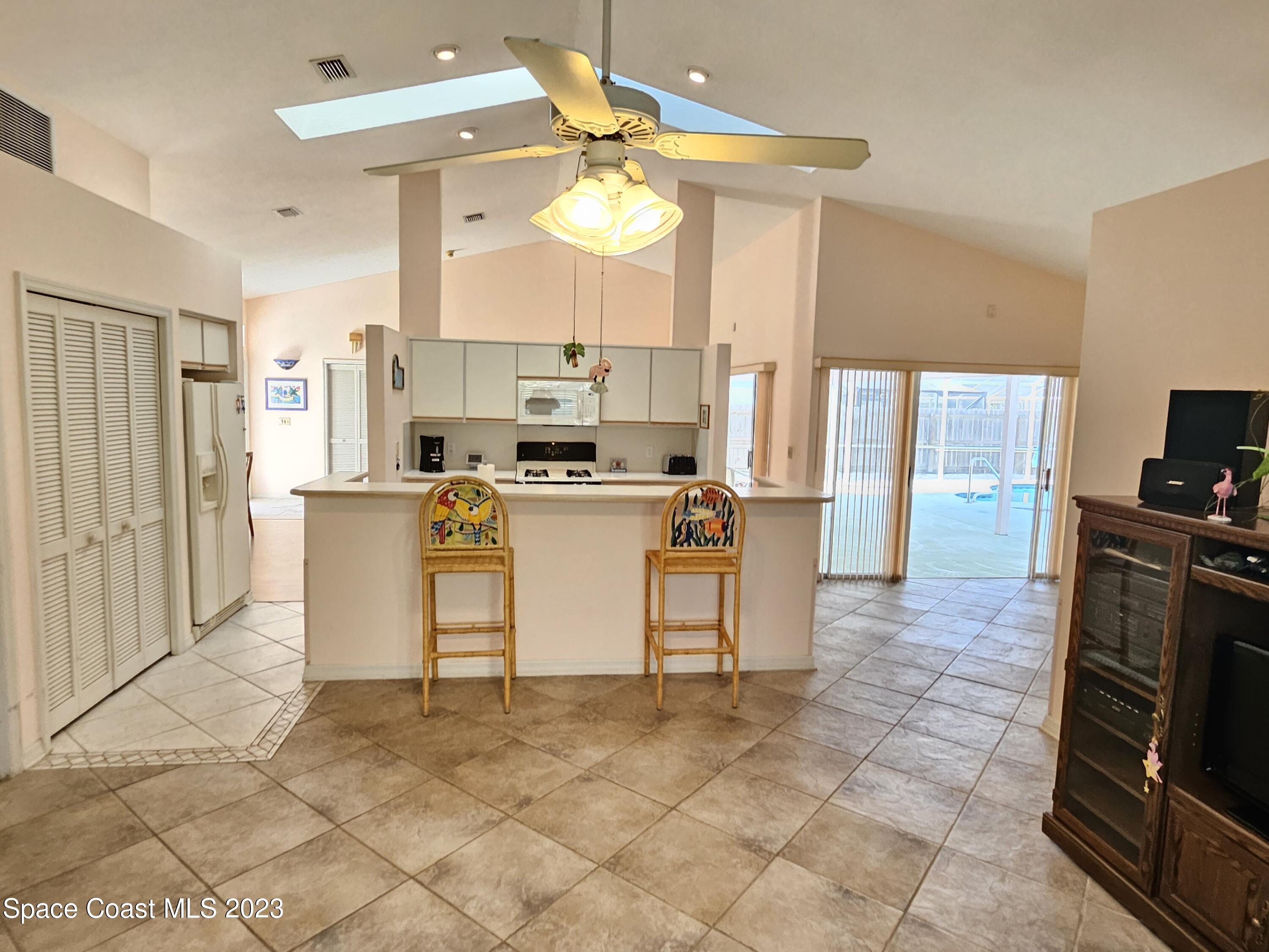 1910 Glen Meadows Circle Melbourne, FL 32935 - Photo 17 of 28 a kitchen with stainless steel appliances granite countertop a stove top oven a sink dishwasher and a refrigerator with wooden floor