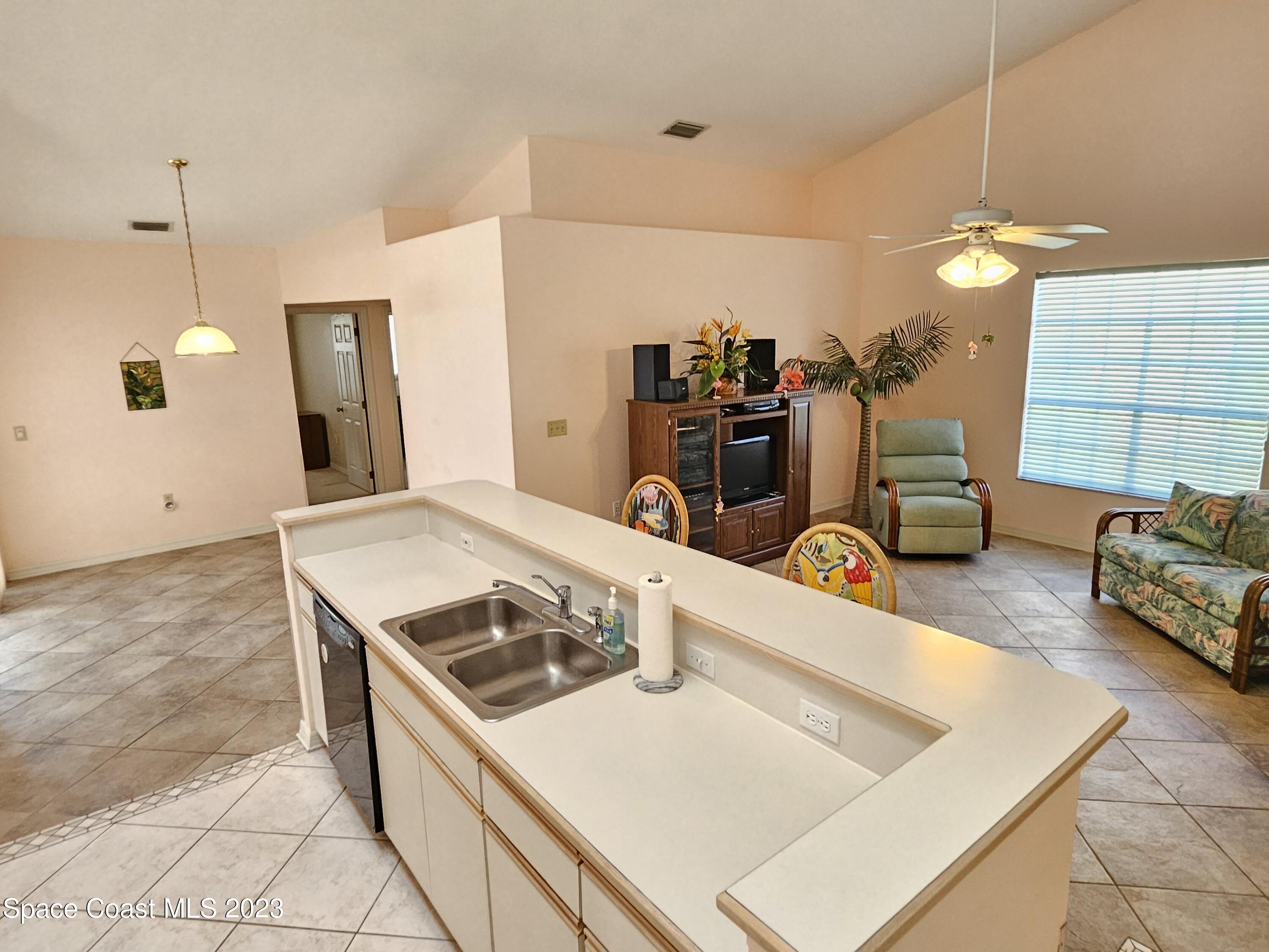 1910 Glen Meadows Circle Melbourne, FL 32935 - Photo 20 of 28 a kitchen with a stove and a refrigerator