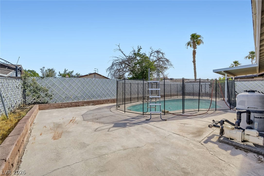 6321 Portola Road Las Vegas, NV 89108 - Photo 27 of 29 A private outdoor space with a fenced pool offers relaxation and leisure under clear skies.
