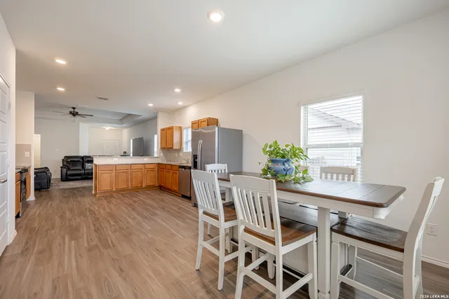 a dining room with furniture and wooden floor