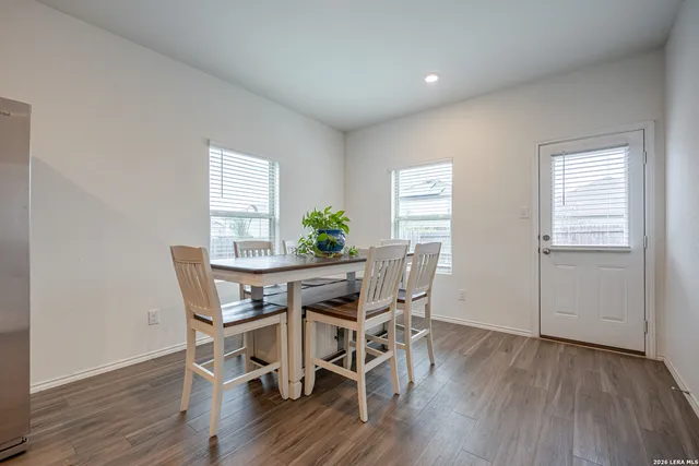 a view of a dining room with furniture and wooden floor