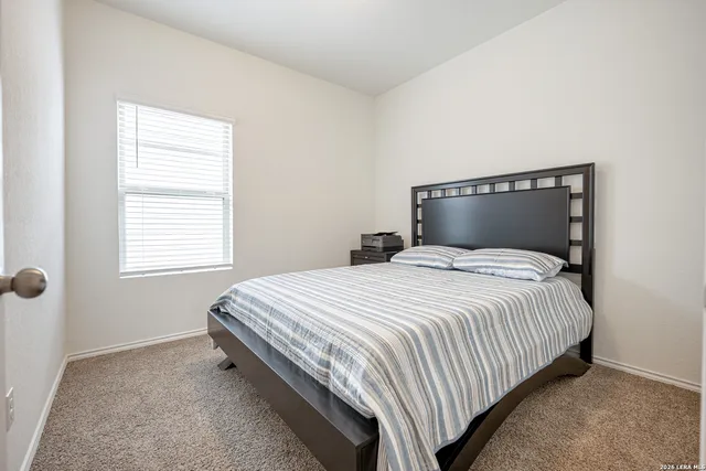 a bedroom with a bed and window