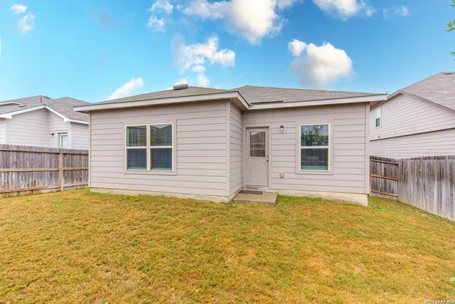 a view of a house with a backyard