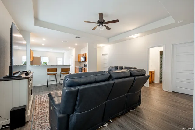 a living room with furniture and a wooden floor