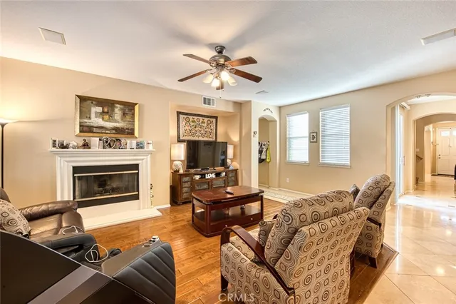 a living room with furniture a fireplace and a flat screen tv