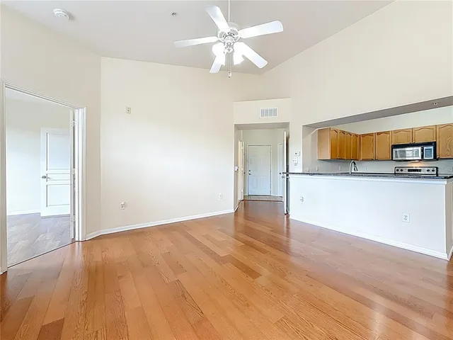 a kitchen with stainless steel appliances granite countertop a sink a stove cabinets and a granite counter top