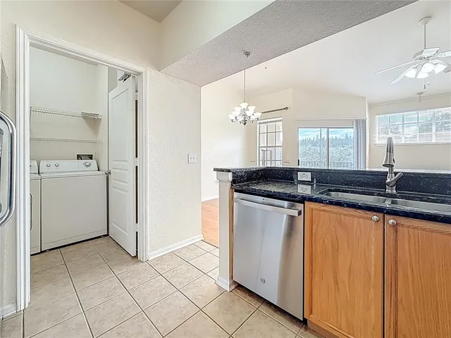 a kitchen with granite countertop a sink and a stove