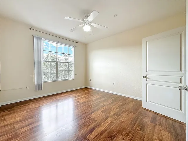 a bathroom with granite countertop double vanity and a mirror