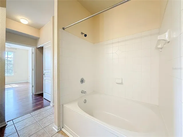 a bathroom with a glass door shower and a toilet