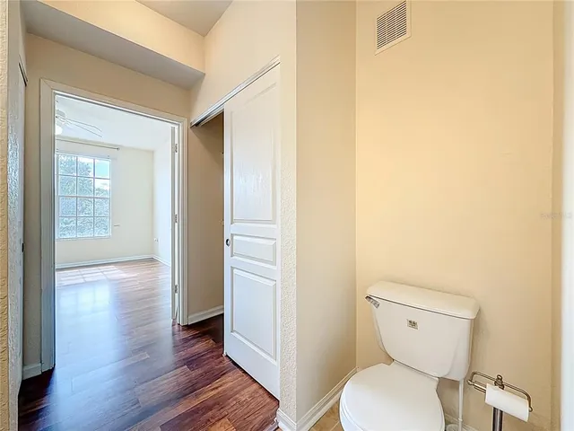 a bathroom with a granite countertop sink a mirror and a bathtub