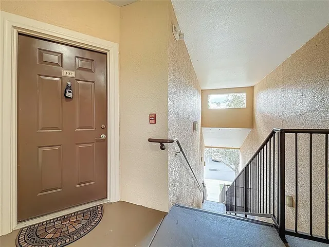 a view of a kitchen with a sink and a chandelier fan