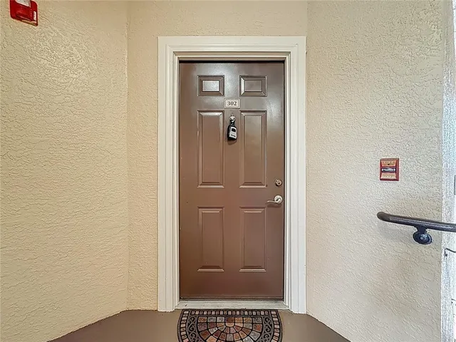 a view of a kitchen with wooden floor and a ceiling fan