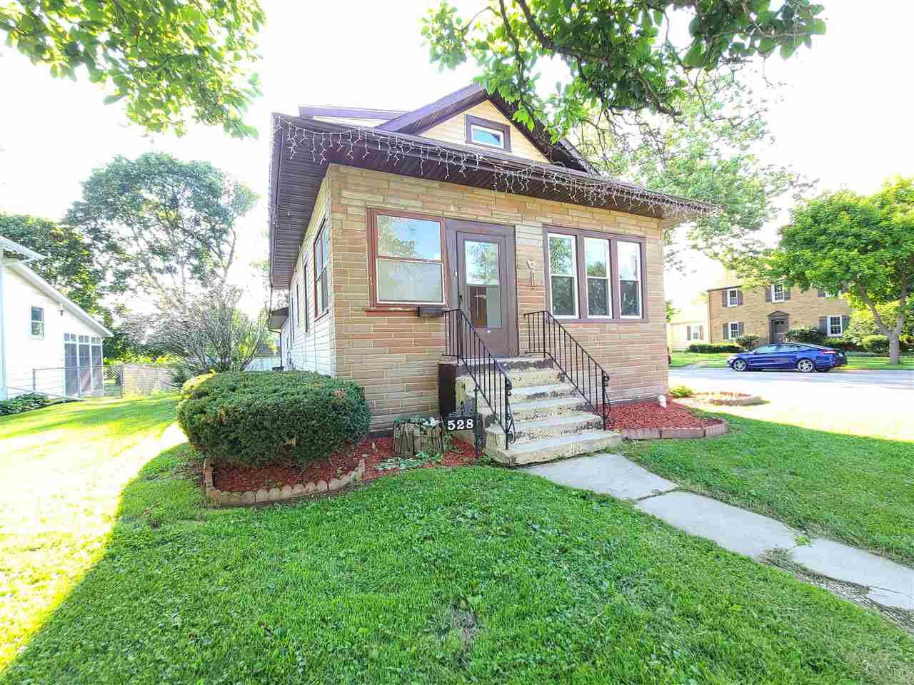 528 North 12th Street Rochelle, IL 61068 - Photo 1 of 16 a front view of a house with garden and porch